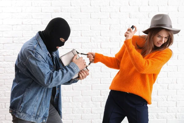Young Woman Pepper Spray Defending Herself Thief White Brick Background — Stock Photo, Image