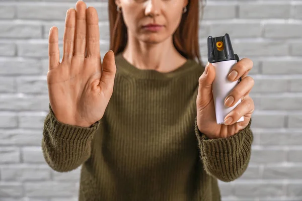 Young Woman Pepper Spray Self Defence Showing Stop Gesture Grey — Stock Photo, Image