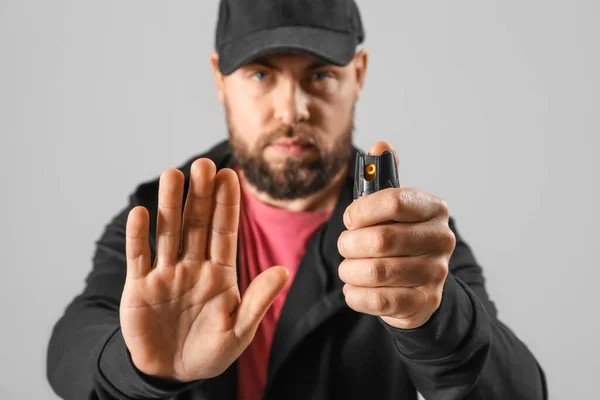 Young Man Pepper Spray Self Defence Showing Stop Gesture Grey — Stock Photo, Image