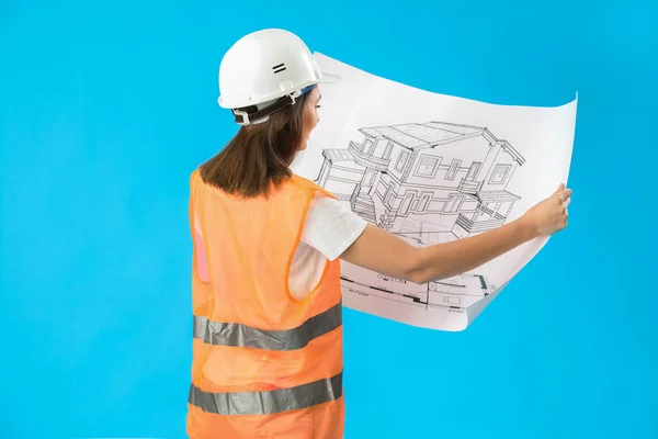 Female engineer with drawing on blue background