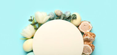 Blank card with flowers, eggs and sweets on blue background. Novruz Bayram celebration