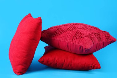 Red decorative pillows on blue background