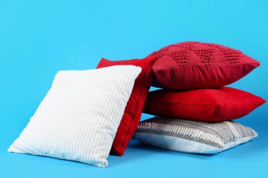 Stack of decorative pillows on blue background