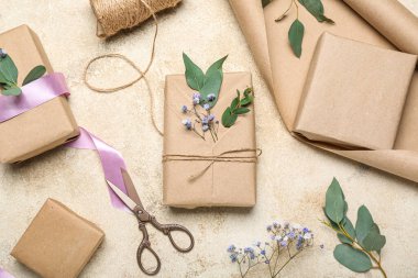 Composition with gift boxes, wrapping paper, rope and gypsophila flowers on light background. Women's Day celebration