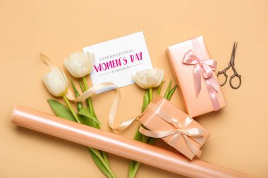Composition with gift boxes, greeting card, wrapping paper and tulip flowers on color background. Women's Day celebration