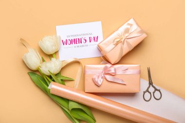 Composition with gift boxes, greeting card, wrapping paper and tulip flowers on color background. Women's Day celebration