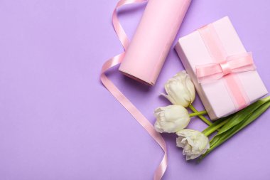 Composition with gift box, wrapping paper and tulip flowers on color background. Women's Day celebration