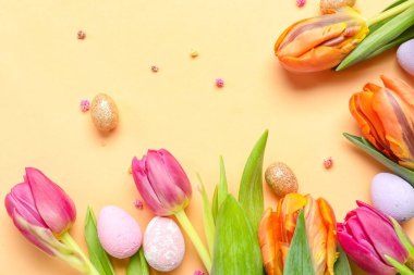 Composition with beautiful tulip flowers and Easter eggs on color background