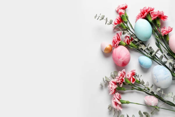 Composition Painted Easter Eggs Carnation Flowers Eucalyptus Branches White Background — Zdjęcie stockowe