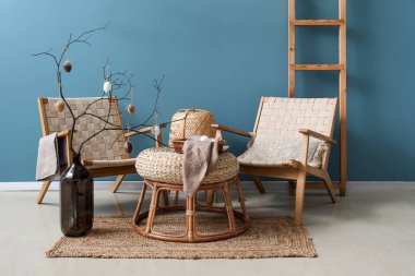 Interior of living room decorated for Easter celebration with tree branches