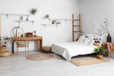 Stylish interior of light bedroom with Easter decor and comfortable bed