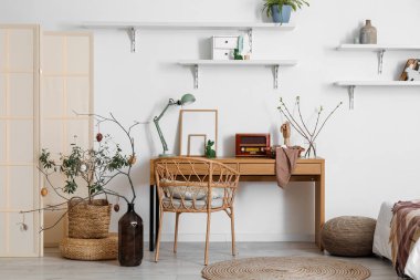 Stylish interior of room with Easter decor and eggs on table