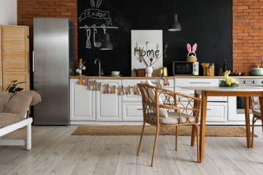 Interior of kitchen with Easter decor, counters and dining table