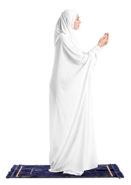 Praying Muslim woman on white background