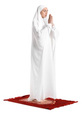 Praying Muslim woman on white background