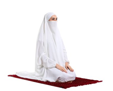 Praying Muslim woman on white background