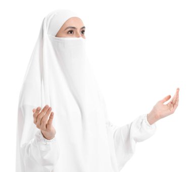 Praying Muslim woman on white background