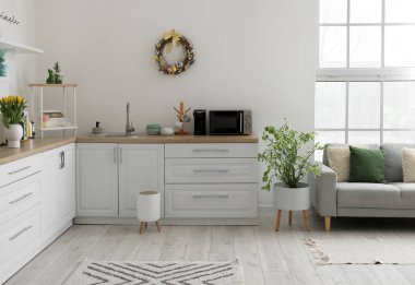 Interior of kitchen with Easter wreath and white counters