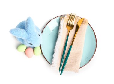 Table serving with Easter eggs and bunny isolated on white background