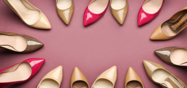 Frame made of different stylish high heeled shoes on pink background. Banner for design