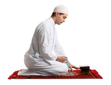 Praying Muslim man on white background