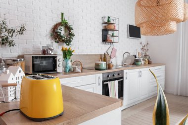 Interior of light kitchen with Easter wreath and white counters