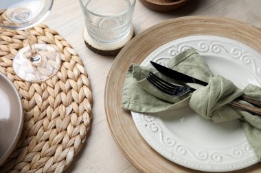 Stylish table setting with cutlery and plates on white wooden background