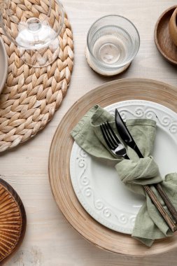 Stylish table setting with cutlery and plates on white wooden background