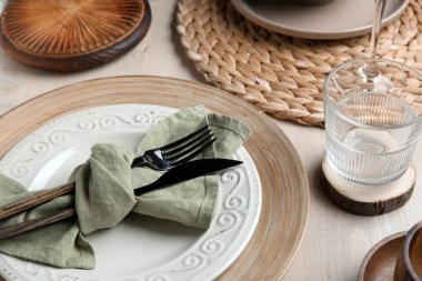 Stylish table setting with cutlery and plates on white wooden background, closeup