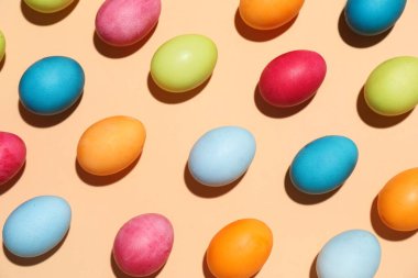 Many colorful Easter eggs on color background