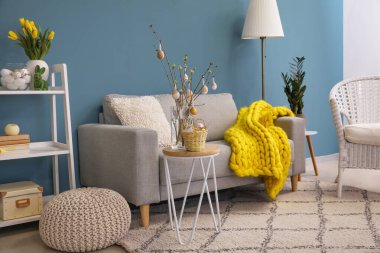 Interior of living room with sofa and Easter decor