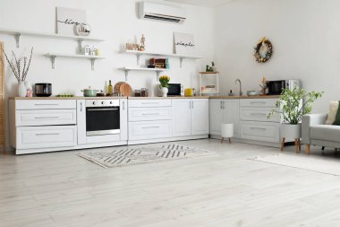 Interior of kitchen with Easter decor, white counters and shelves