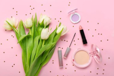 Composition with beautiful tulip flowers and decorative cosmetics on pink background