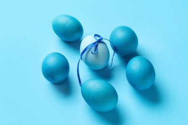 Composition with painted Easter eggs on blue background