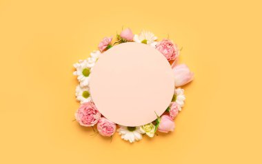 Composition with blank card and beautiful spring flowers on color background