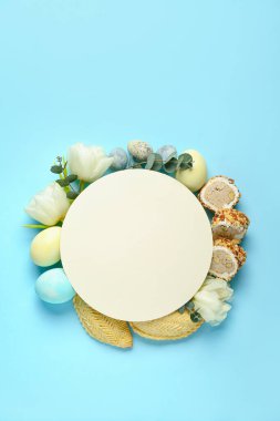 Blank card with flowers, eggs and treats on blue background. Novruz Bayram celebration