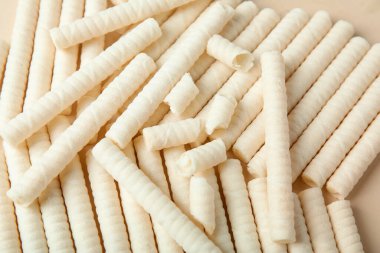 Delicious wafer rolls as background, closeup