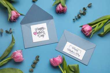 Composition with greeting cards and beautiful tulip flowers on color background. Mother's day celebration