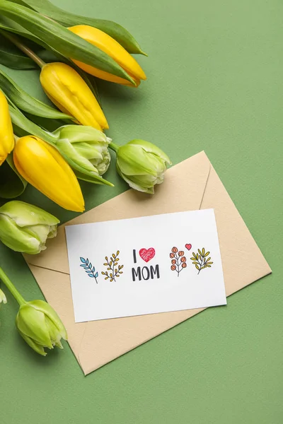Envelope, card with text I LOVE MOM and tulips on green background