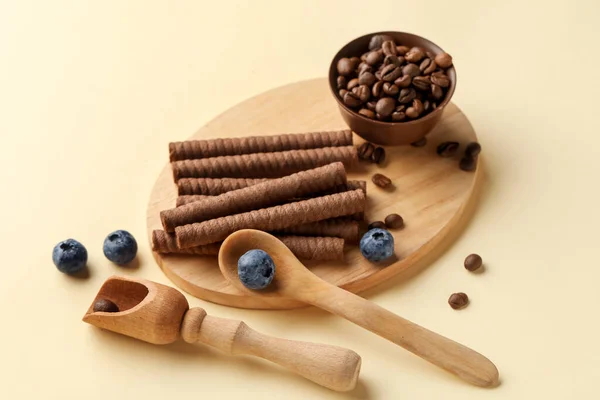 Board Delicious Chocolate Wafer Rolls Coffee Beans Blueberries Beige Background — Stock Photo, Image