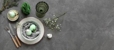 Stylish table setting for Easter celebration with gypsophila flowers on grunge background with space for text