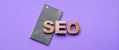 Abbreviation SEO with notebook on purple background
