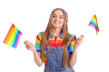 Beautiful young woman with LGBT flags on white background