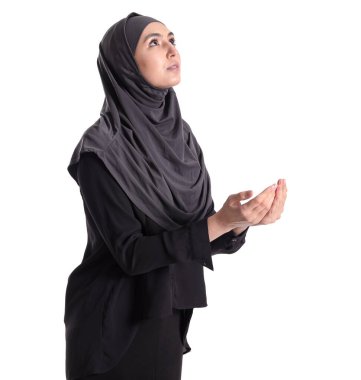 Praying Muslim woman on white background