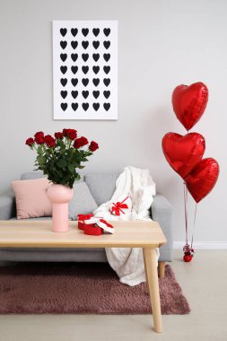 Interior of living room decorated for Valentine's Day with roses, gifts and balloons