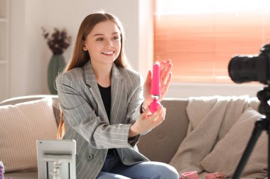 Female blogger with vibrator conducting sex education online at home
