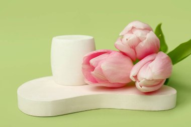 Podiums with pink tulips on green background. Hello spring