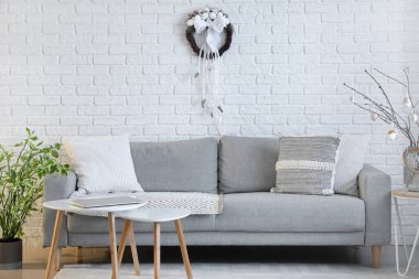 Interior of living room with Easter wreath and sofa