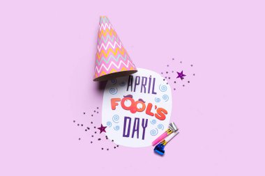 Composition with text APRIL FOOL'S DAY, party hat and whistles on color background