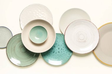 Composition with stylish ceramic plates on light background